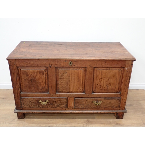 748 - An 18th Century oak Mule Chest with fielded three panel front above two drawers to base, mounted on ... 