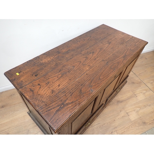 748 - An 18th Century oak Mule Chest with fielded three panel front above two drawers to base, mounted on ... 