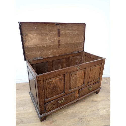 748 - An 18th Century oak Mule Chest with fielded three panel front above two drawers to base, mounted on ... 