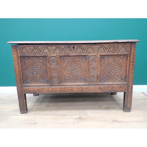 749 - A 17th Century oak Coffer with plank lid above arcaded frieze and three diamond and rosette panels, ... 