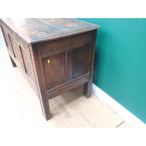 749 - A 17th Century oak Coffer with plank lid above arcaded frieze and three diamond and rosette panels, ... 