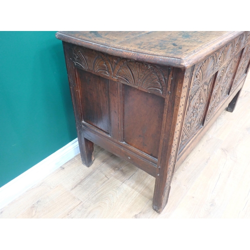 749 - A 17th Century oak Coffer with plank lid above arcaded frieze and three diamond and rosette panels, ... 