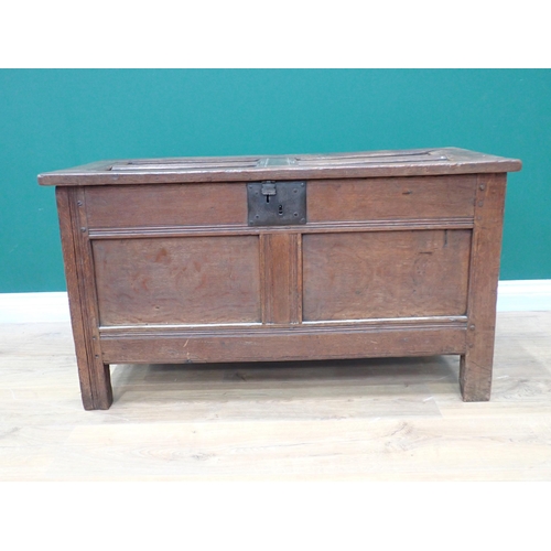 751 - A 17th Century small oak Coffer with sunken four panel lid above iron lockplate and two panel front,... 