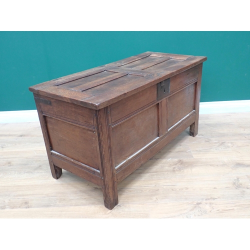 751 - A 17th Century small oak Coffer with sunken four panel lid above iron lockplate and two panel front,... 