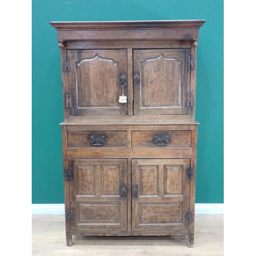 752 - An 18th Century oak Cwpwrydd deuddarn fitted pair of cupid's bow fielded panel doors to upper sectio... 