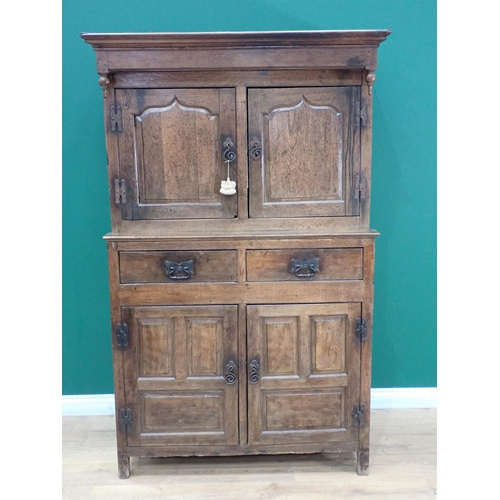 752 - An 18th Century oak Cwpwrydd deuddarn fitted pair of cupid's bow fielded panel doors to upper sectio... 