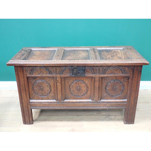 754 - A small 18th Century oak Coffer with panelled top above a rose and lunette panelled carved front