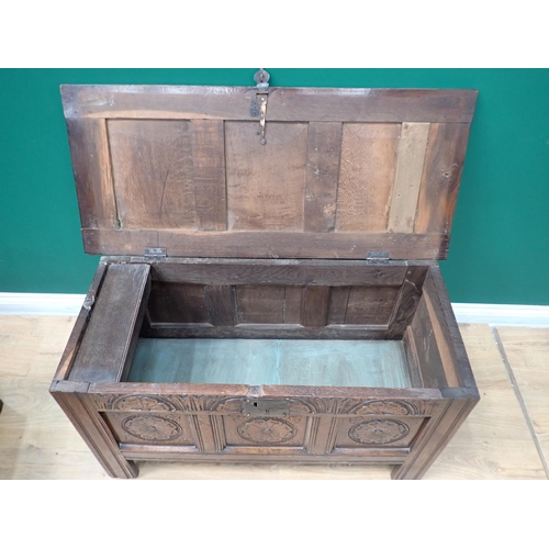 754 - A small 18th Century oak Coffer with panelled top above a rose and lunette panelled carved front