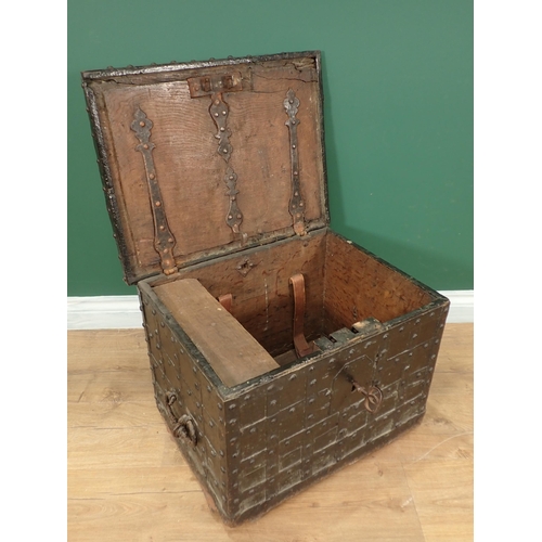 755 - A 17th Century iron bound oak Strong Box with single key lock, two handles and strap hinged lid encl... 