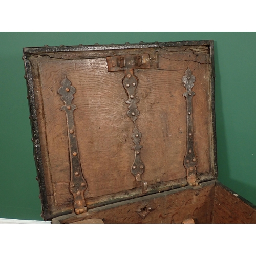 755 - A 17th Century iron bound oak Strong Box with single key lock, two handles and strap hinged lid encl... 