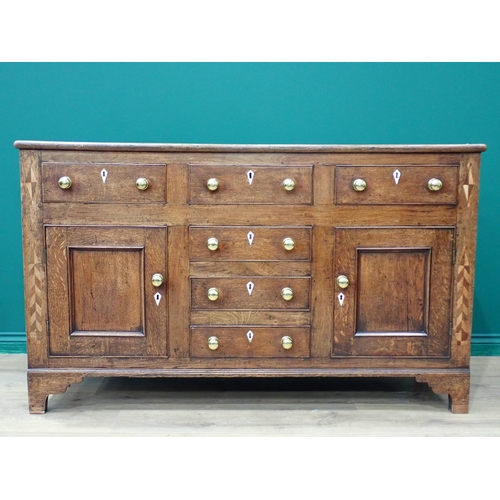 757 - A George III oak enclosed Dresser Base with feather banded inlay fitted three frieze drawers above a... 