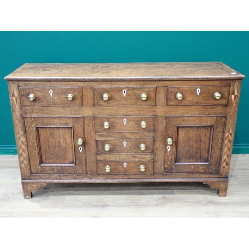 757 - A George III oak enclosed Dresser Base with feather banded inlay fitted three frieze drawers above a... 