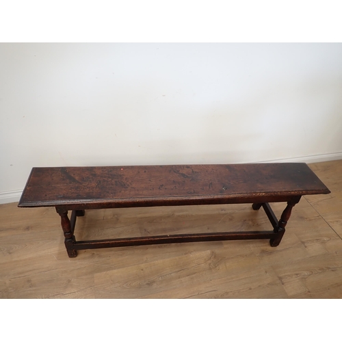 760 - A long joined oak Refectory Bench in the 17th Century style with moulded top mounted upon turned sup... 