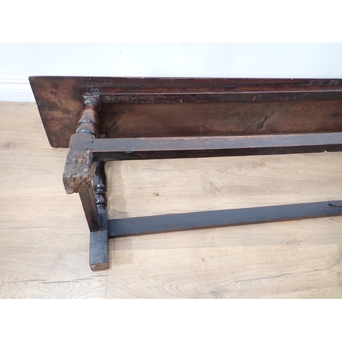 760 - A long joined oak Refectory Bench in the 17th Century style with moulded top mounted upon turned sup... 