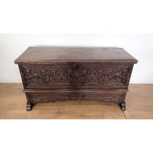 761 - A 17th Century and later oak plank Chest with plain moulded lid above profusely carved front with fo... 