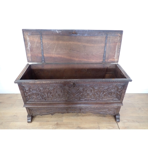 761 - A 17th Century and later oak plank Chest with plain moulded lid above profusely carved front with fo... 