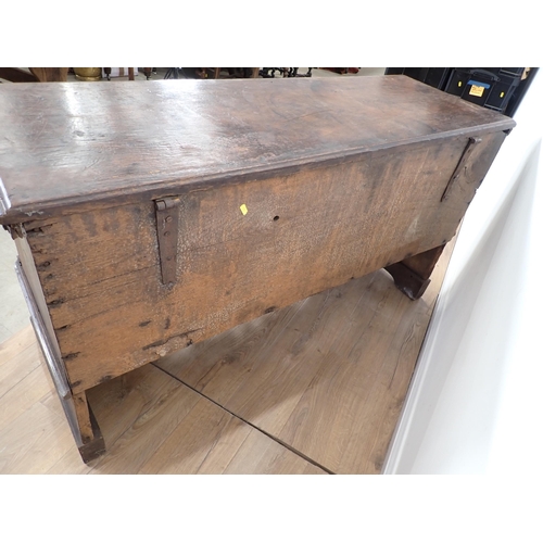 761 - A 17th Century and later oak plank Chest with plain moulded lid above profusely carved front with fo... 