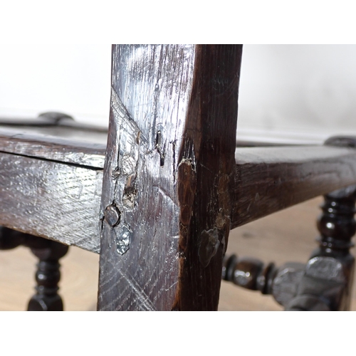 762 - Two 17th Century and later oak Derbyshire Chairs both with mask and scroll carved double back rails