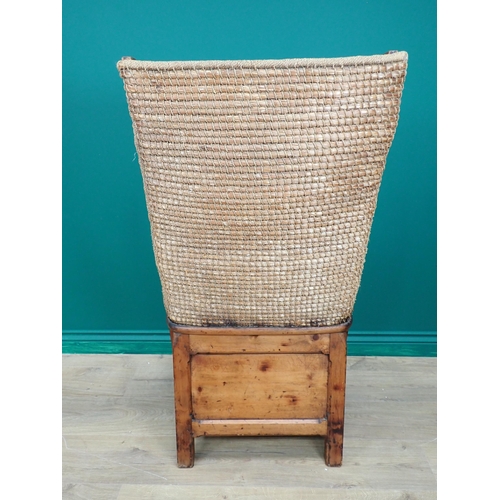 763 - A late 19th or early 20th Century pine Orkney Chair with traditional woven back, scroll ends to arm ... 