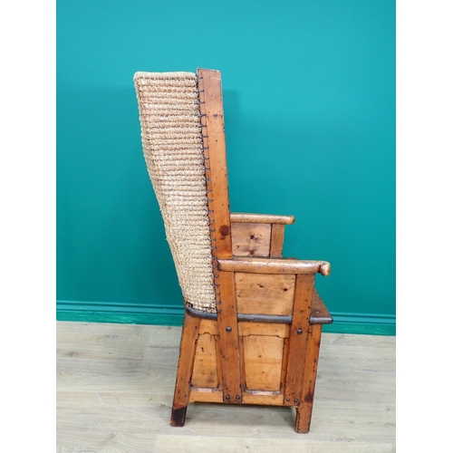 763 - A late 19th or early 20th Century pine Orkney Chair with traditional woven back, scroll ends to arm ... 