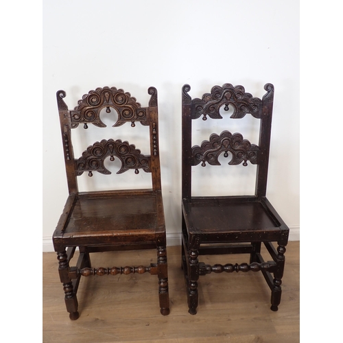 766 - Two 17th Century and later oak Derbyshire Chairs both with scroll carved double back rails, one show... 