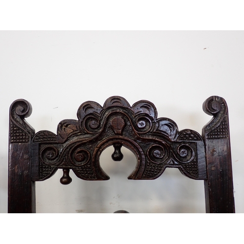 766 - Two 17th Century and later oak Derbyshire Chairs both with scroll carved double back rails, one show... 