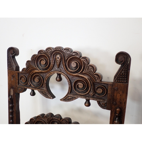 766 - Two 17th Century and later oak Derbyshire Chairs both with scroll carved double back rails, one show... 