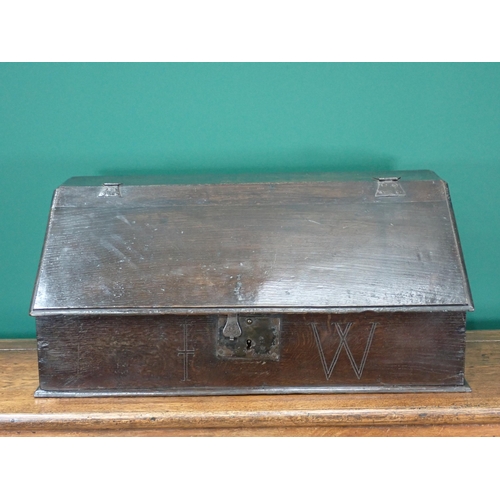 767 - An early 18th Century oak Bible Box with moulded hinged lid enclosing pigeon holes and three drawers... 