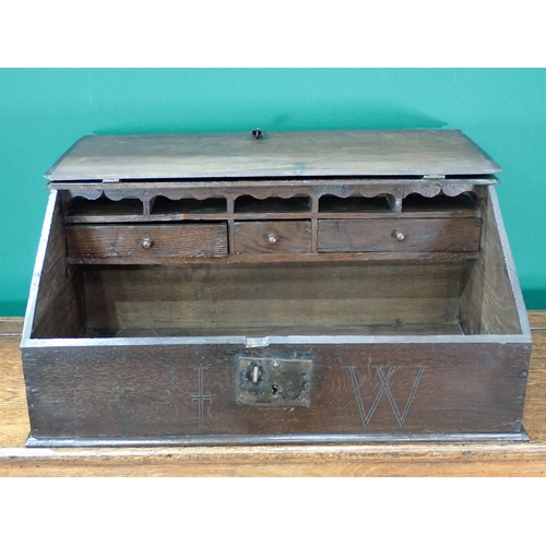 767 - An early 18th Century oak Bible Box with moulded hinged lid enclosing pigeon holes and three drawers... 