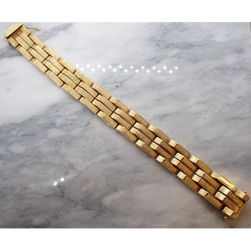 85 - An 18ct gold Bracelet formed from textured, rectangular, angled links, in the style of Kutchinsky, a... 