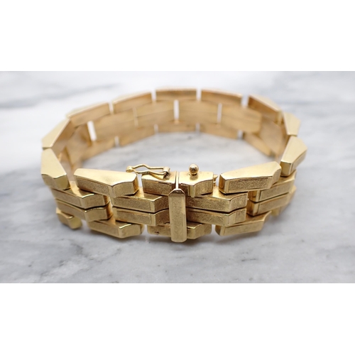 85 - An 18ct gold Bracelet formed from textured, rectangular, angled links, in the style of Kutchinsky, a... 