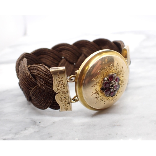 89 - A 19th Century woven hair Bracelet with engraved yellow metal clasp set flower cluster of cushion-cu... 