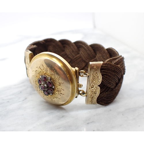 89 - A 19th Century woven hair Bracelet with engraved yellow metal clasp set flower cluster of cushion-cu... 