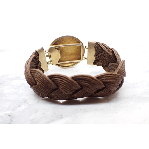 89 - A 19th Century woven hair Bracelet with engraved yellow metal clasp set flower cluster of cushion-cu... 