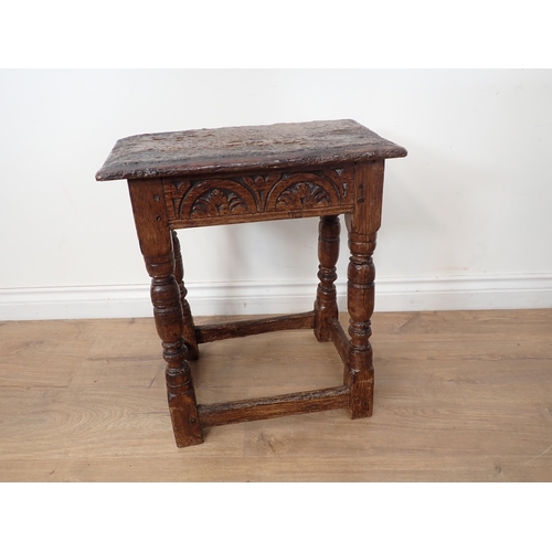 77 - An antique oak Joint Stool in the 17th Century style with rustic top and lunette carved frieze mount... 