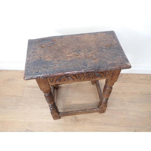 77 - An antique oak Joint Stool in the 17th Century style with rustic top and lunette carved frieze mount... 