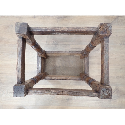 77 - An antique oak Joint Stool in the 17th Century style with rustic top and lunette carved frieze mount... 