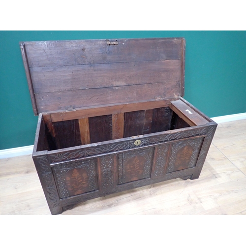 86 - A 17th Century oak Coffer with plank lid above three carved panels having floral inlay, 4ft 9in