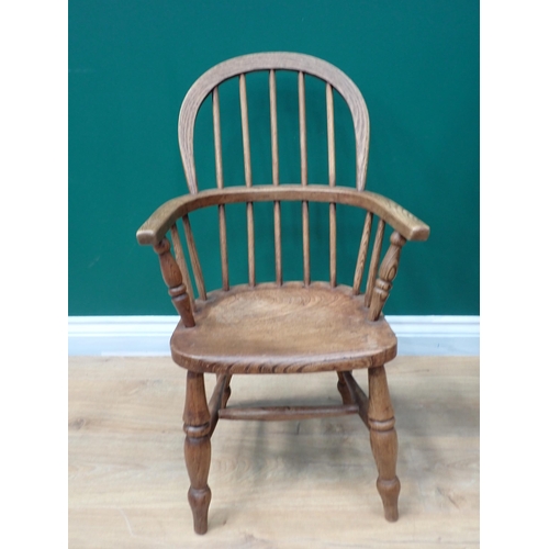 91 - A 19th Century ash and elm child's Windsor Elbow Chair with hoop back on turned supports and stretch... 