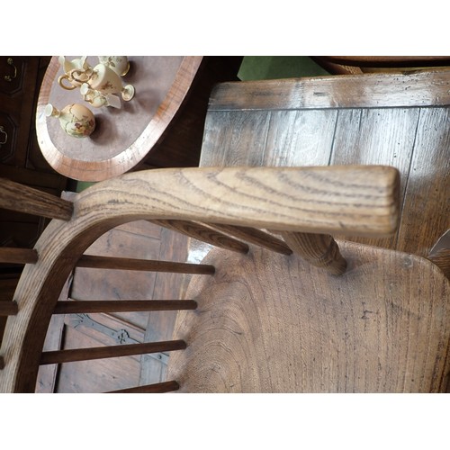 91 - A 19th Century ash and elm child's Windsor Elbow Chair with hoop back on turned supports and stretch... 