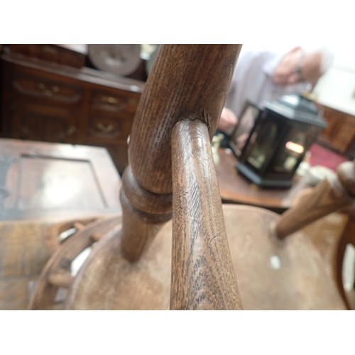 91 - A 19th Century ash and elm child's Windsor Elbow Chair with hoop back on turned supports and stretch... 