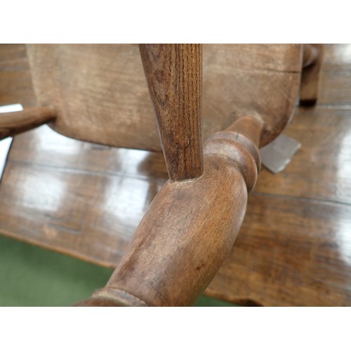 91 - A 19th Century ash and elm child's Windsor Elbow Chair with hoop back on turned supports and stretch... 