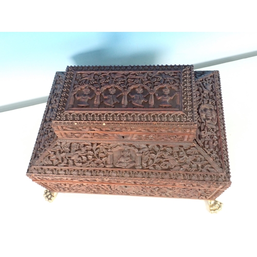 302 - A large carved sandalwood Jewellery Box with hinged upper cover carved with figures, the main hinged... 