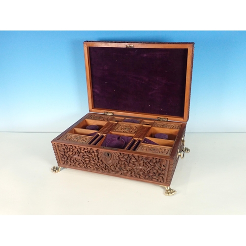 302 - A large carved sandalwood Jewellery Box with hinged upper cover carved with figures, the main hinged... 