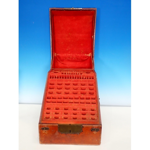 310 - A 19th Century tooled and embossed leather Knife Box with hinged sloping front enclosing a lined and... 