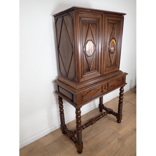 317 - An 18th Century Continental walnut Chest on stand fitted pair of panelled doors having octagonal pai... 