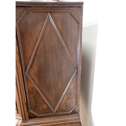 317 - An 18th Century Continental walnut Chest on stand fitted pair of panelled doors having octagonal pai... 