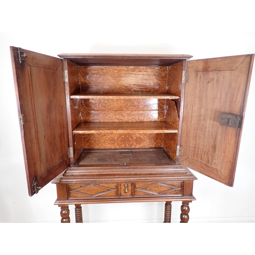 317 - An 18th Century Continental walnut Chest on stand fitted pair of panelled doors having octagonal pai... 