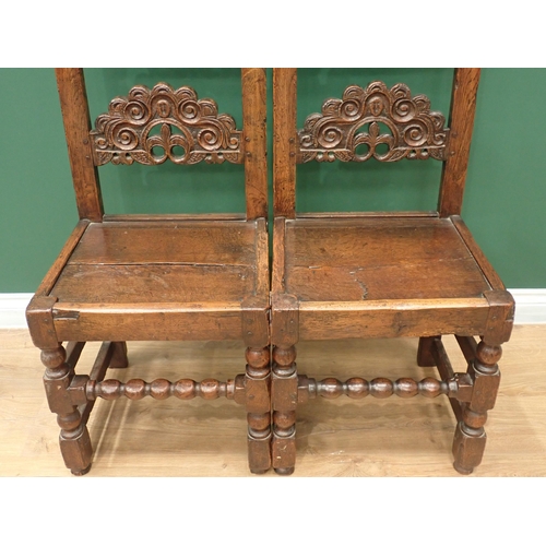 336 - A pair of Charles II style oak Derbyshire with arched scroll, mask and trefoil carved double back ra... 