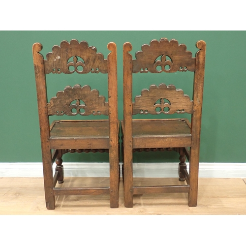 336 - A pair of Charles II style oak Derbyshire with arched scroll, mask and trefoil carved double back ra... 